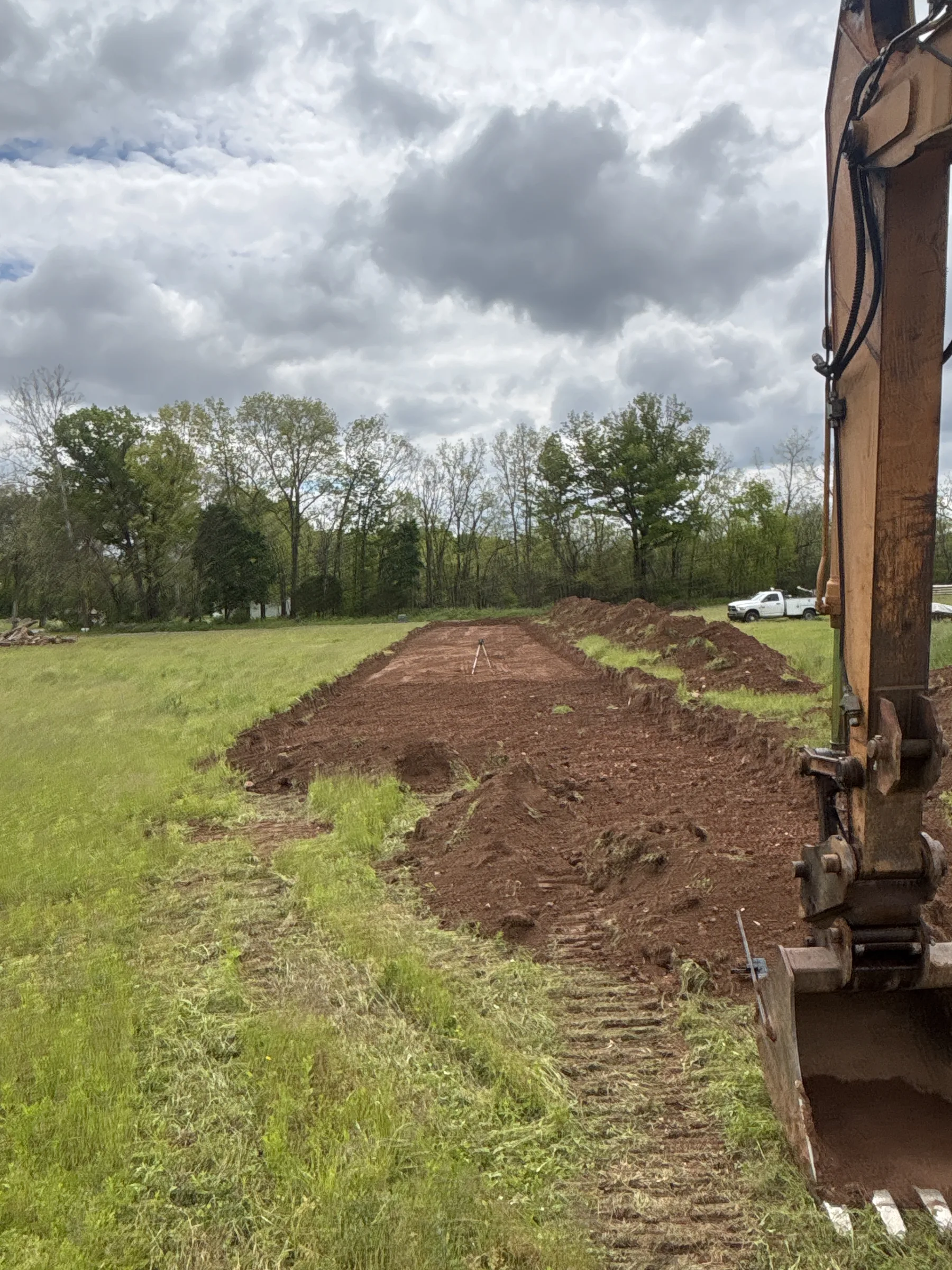 Excavator and skid steer preparing a building site for new construction
