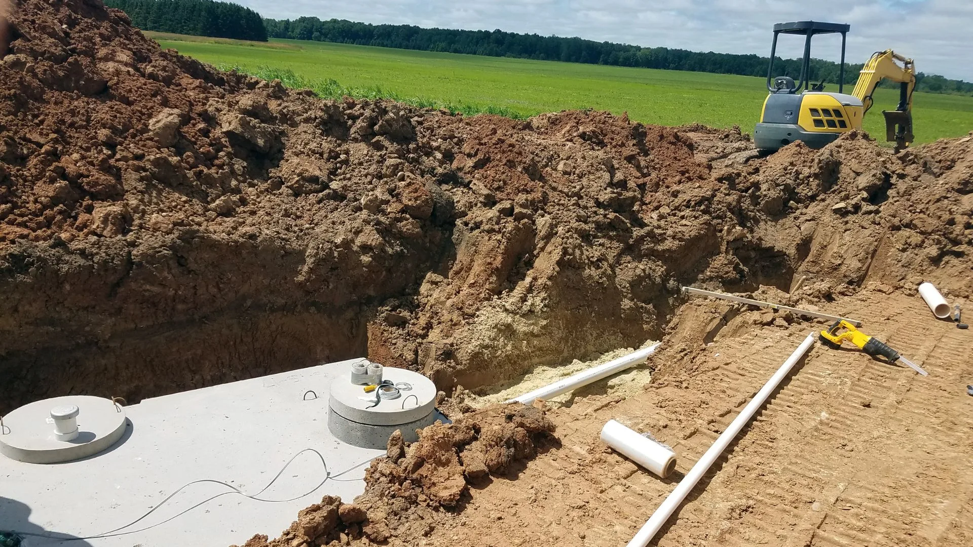 Deep excavation for a septic tank installation with equipment positioning components