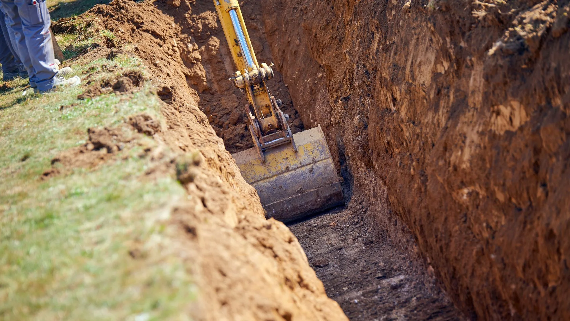 Deep utility trench dug with an excavator bucket