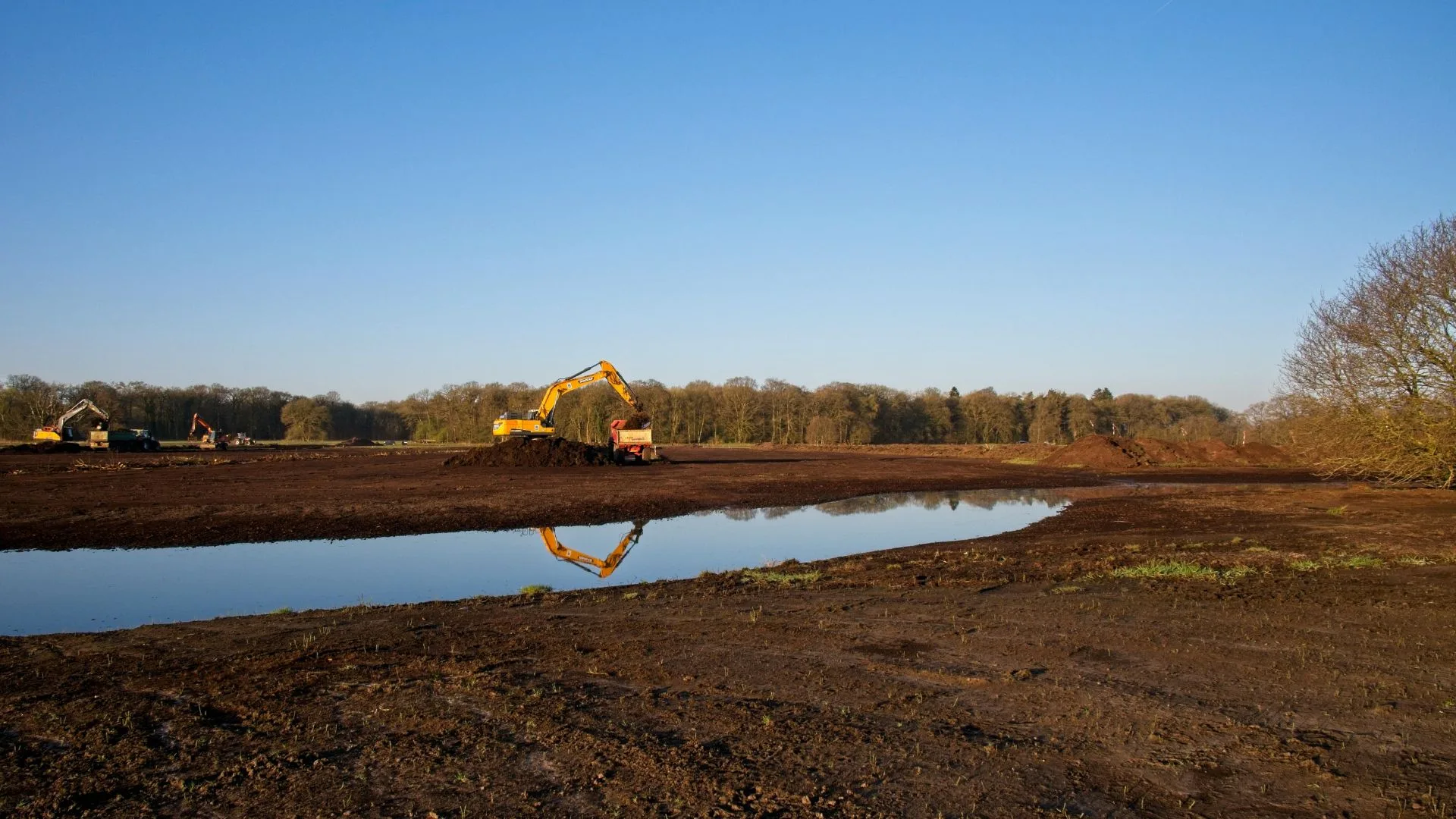 Excavation equipment installing a water service line in a rural setting